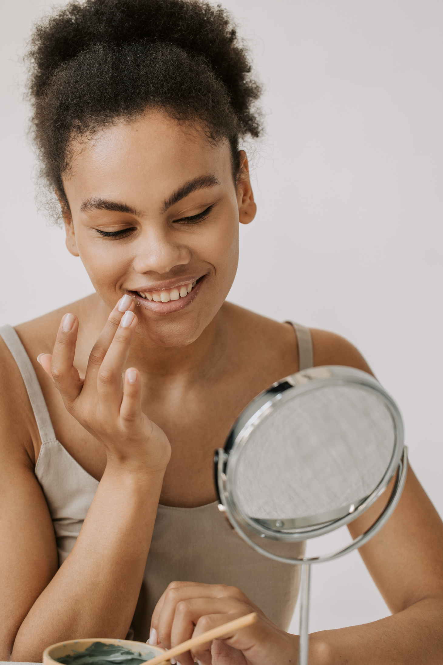 Smiling Woman Looking at the Mirror